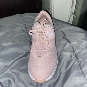 Never been worn, blush pink Nike athletic shoes, size 10 women’s.